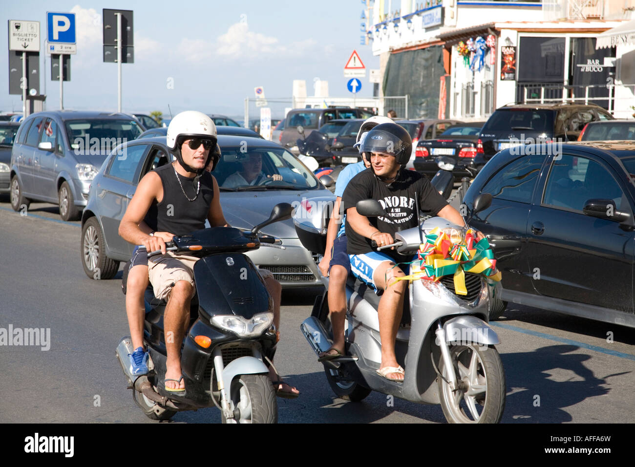 Teenagers riding mopeds in Porto Santo Stefano Monte Argentario Tuscany  Italy Stock Photo - Alamy