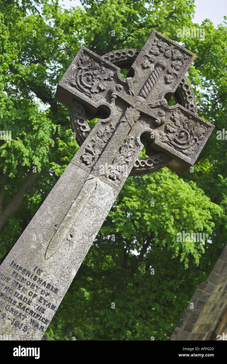 A war memorial in the ground of Eyam Parish Church Derbyshire Stock Photo