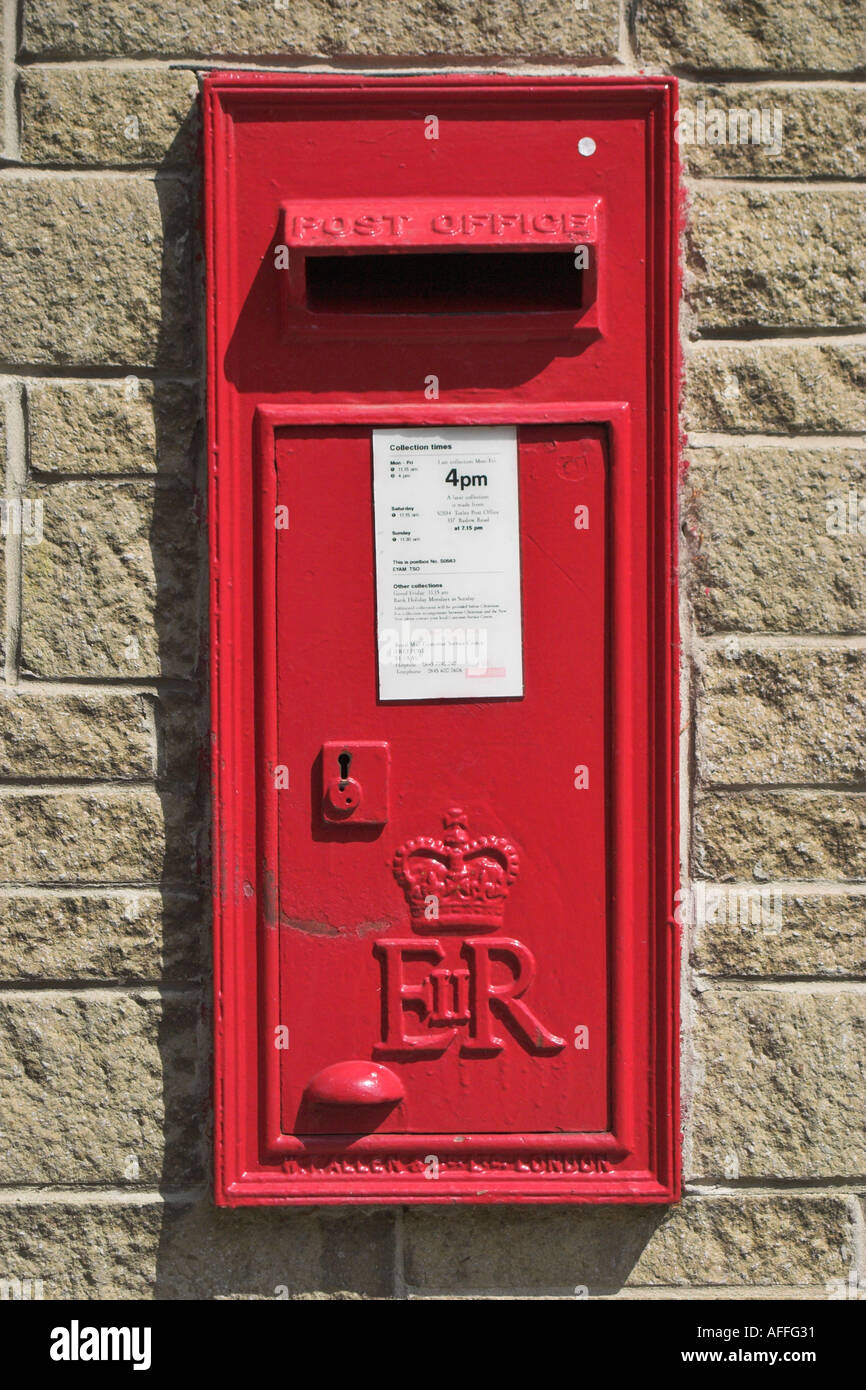 A wall mounted postbox. Eyam, Derbyshire, United Kingdom. Stock Photo