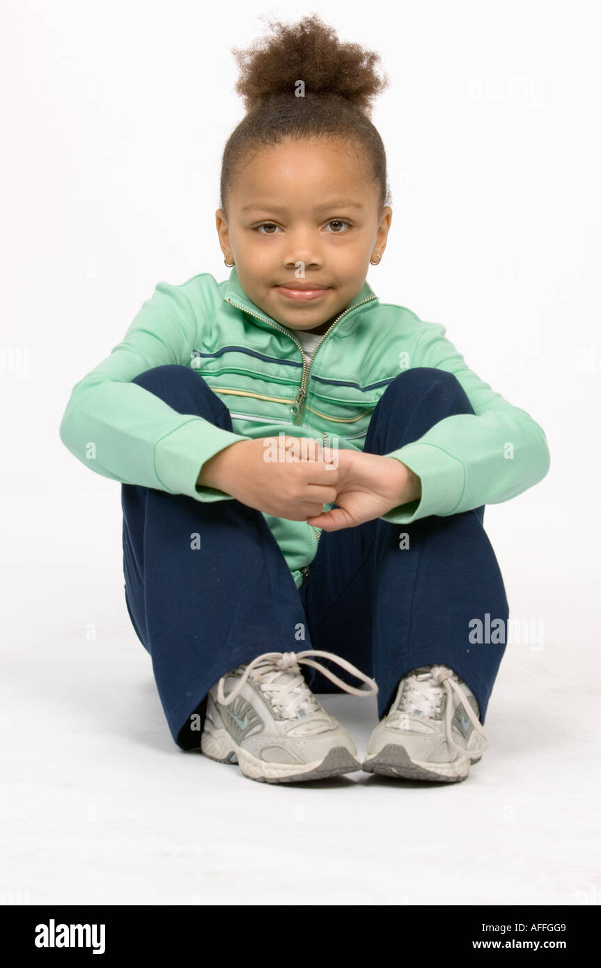 Girl sitting knees up smiling hi-res stock photography and images - Alamy