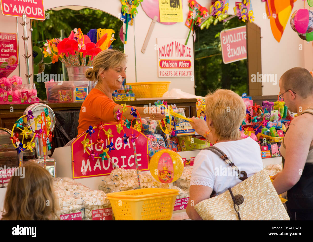 People buying sweets and candy at a pink market stall