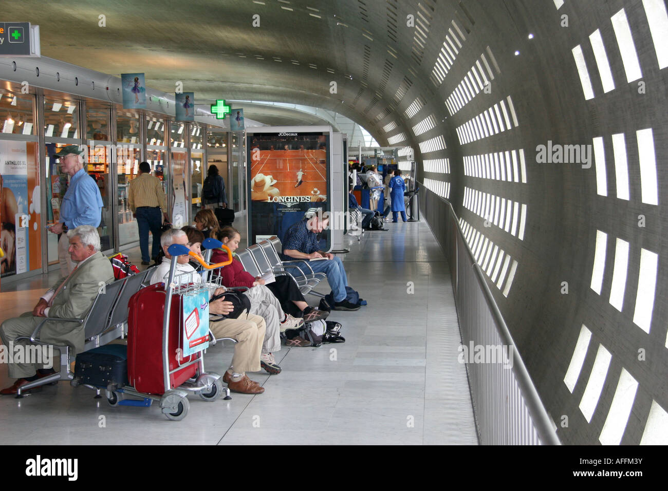 Passengers and shops inside a terminal of Charles de Gaulle airport Stock Photo