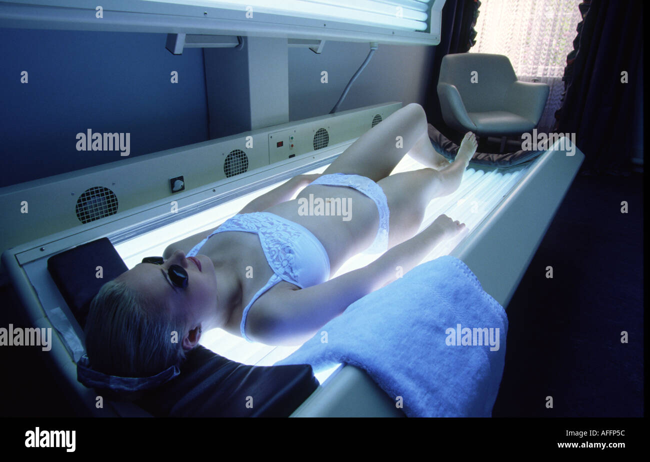 Health Beauty girl on sunbed skin ageing through uv radiation Stock Photo