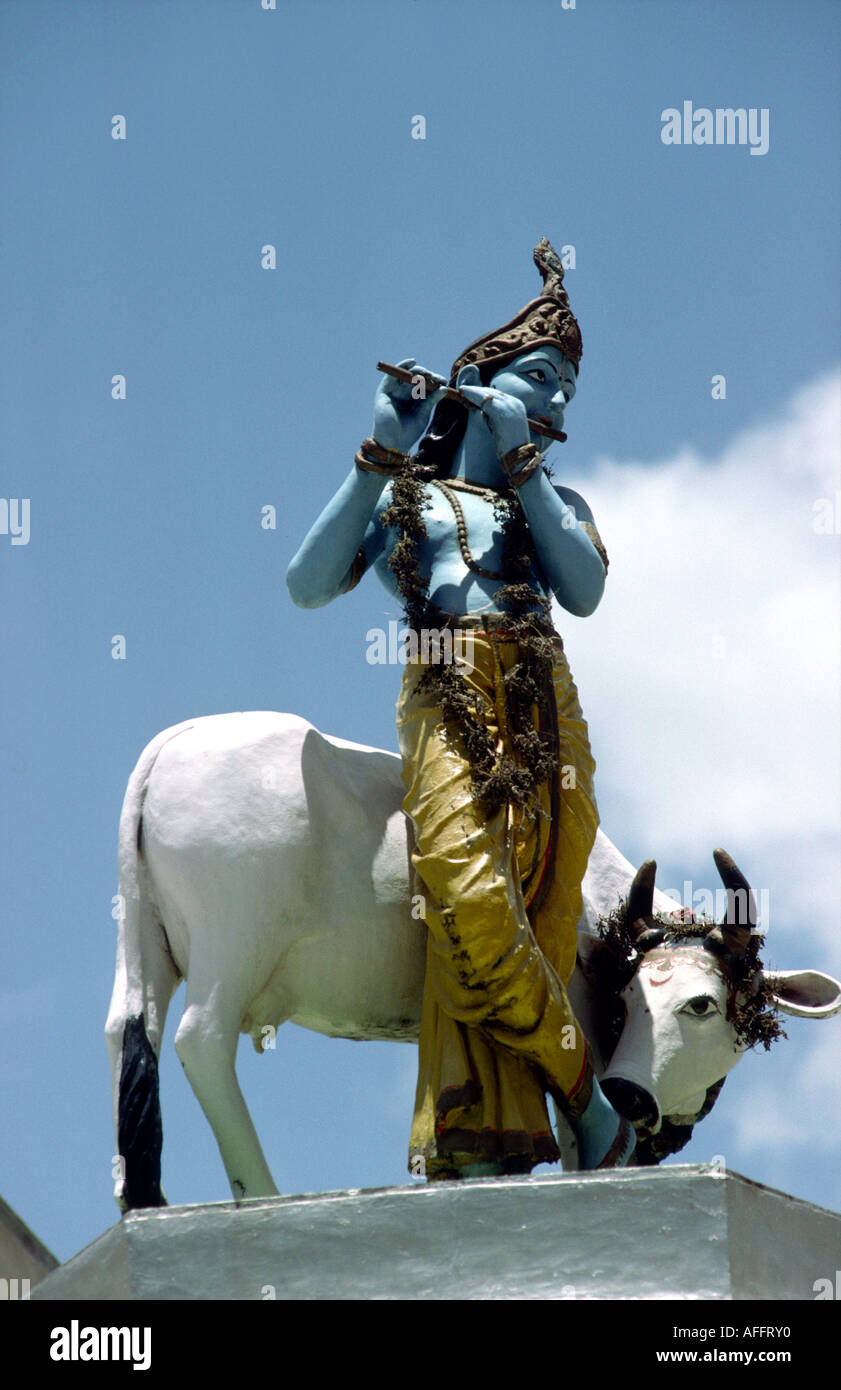 India Karnataka Mysore religion statue of Hindu deity Krishna cow on Temple Roof Stock Photo
