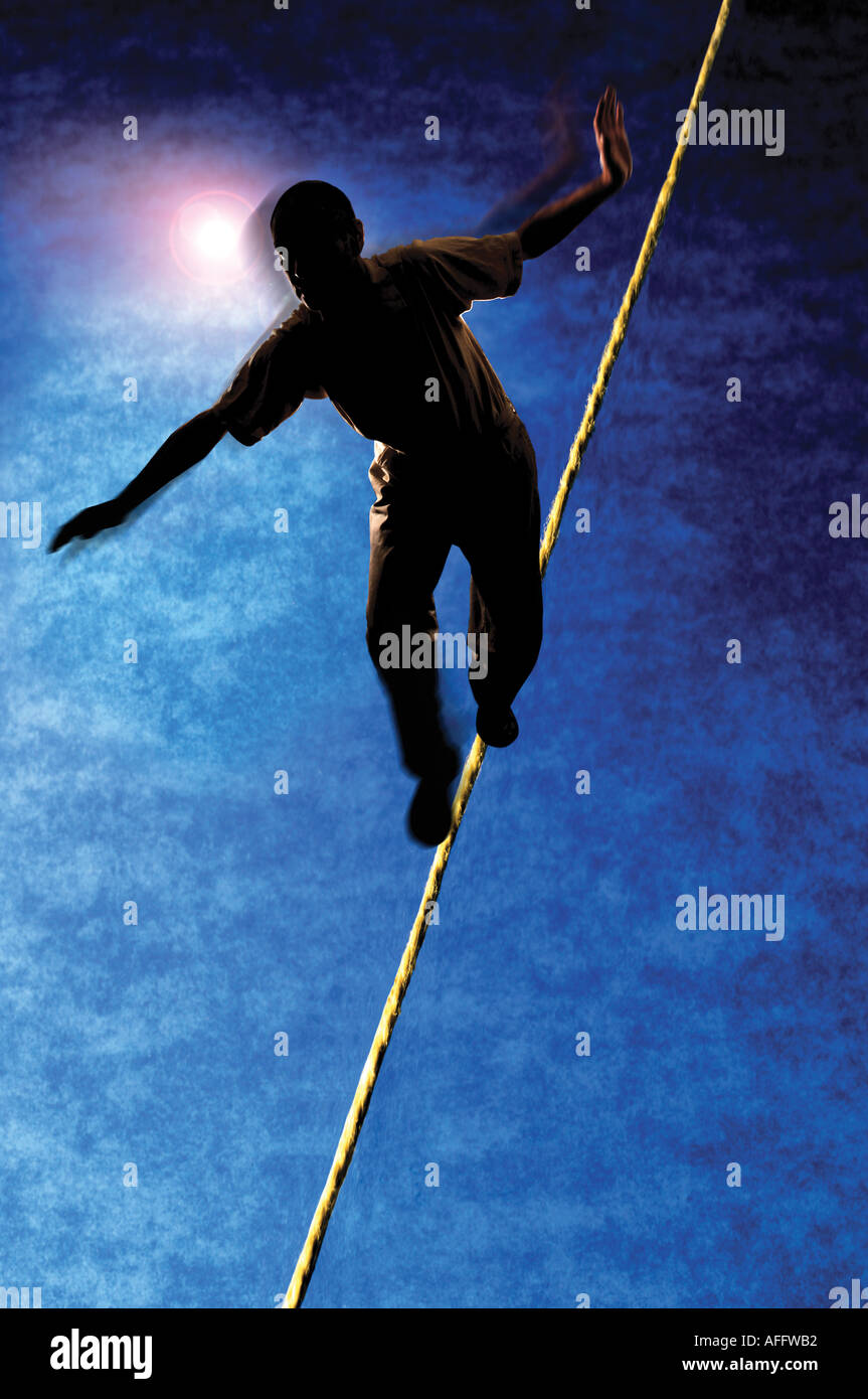 man walking tightrope Stock Photo - Alamy