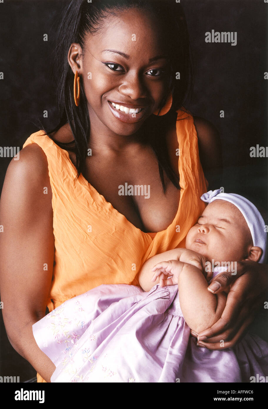 Coloured Mother Holding Her Baby Stock Photo