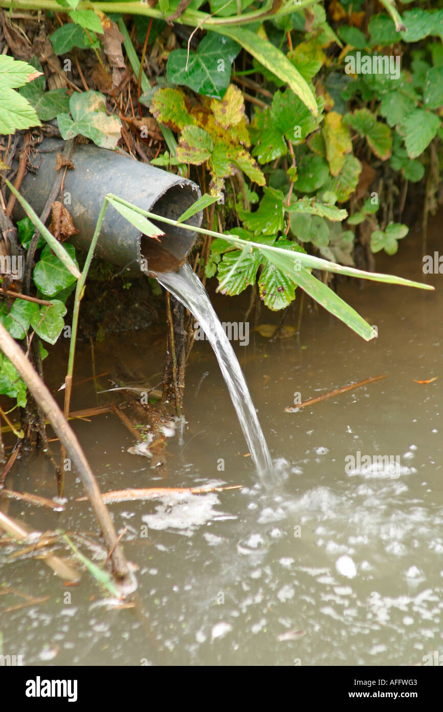 Water running through drainage pipe into river Stock Photo Alamy