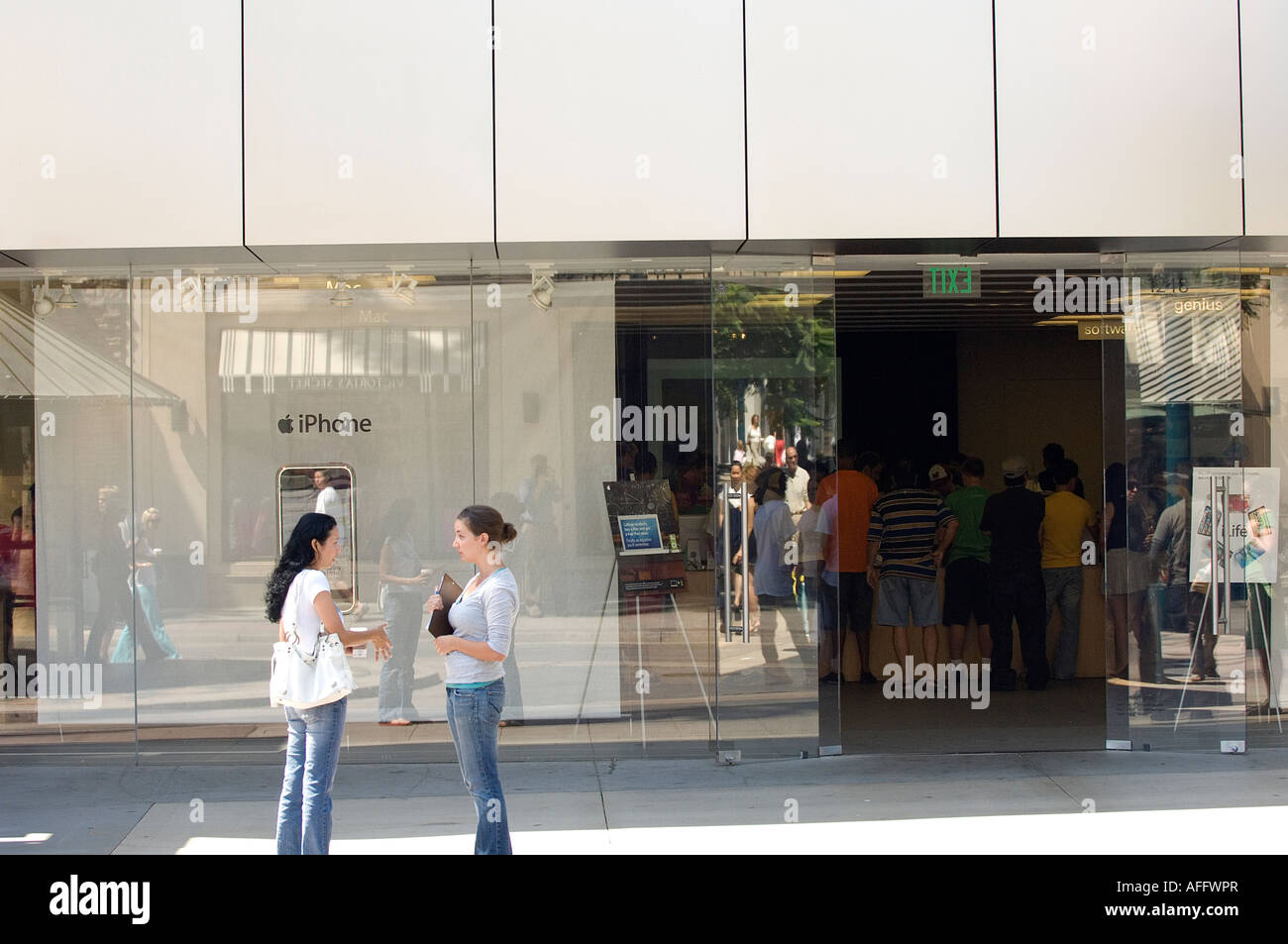 Customers visit the Apple store in Santa Monica, California where they