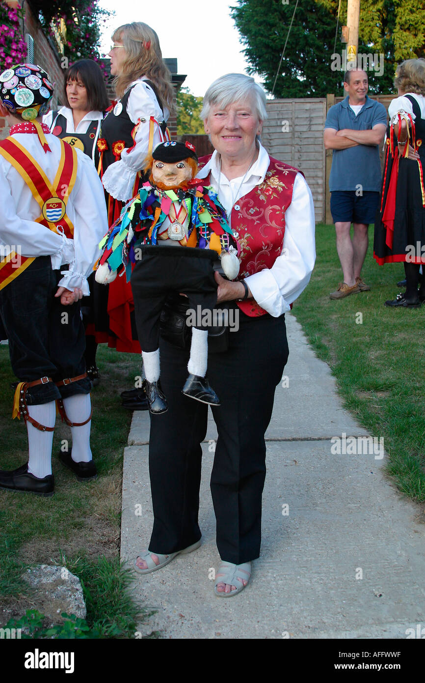 Lady with doll dressed in Morris costume. The doll is used to collect money for the Morris dancers during performances Stock Photo - Alamy
