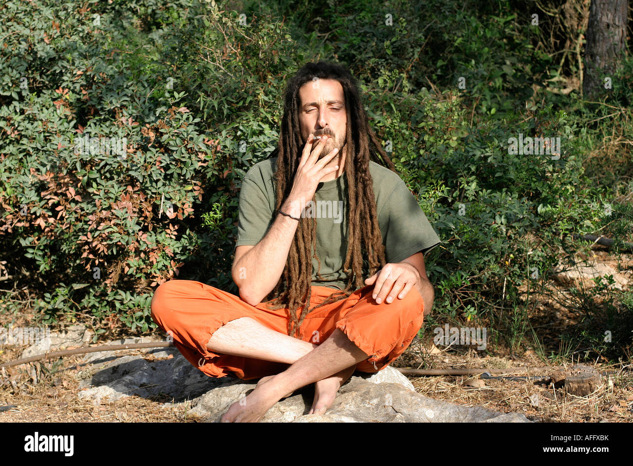 hippy preparing rolling and smoking marijuana joint photos series Stock Photo Alamy