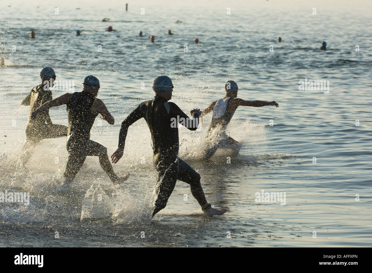 Swimmers run into cold Pacific ocean for swimming section of Santa ...