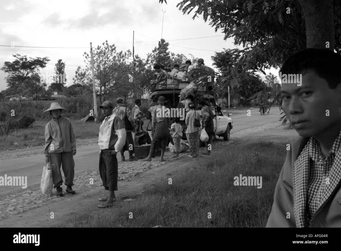 Another bus, another breakdown. A man waits patiently and pensively for the next thing to happen. Stock Photo