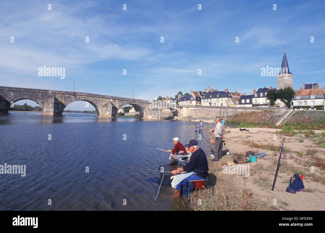 Anglers in front of La Charite s Loire Burgundy France Stock Photo