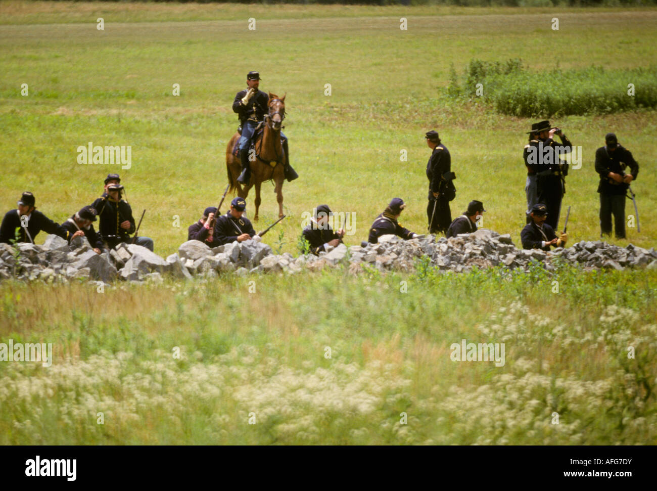 civil war reenactors Gettysburg PA battle field yankee northern army behind stone wall fence Stock Photo