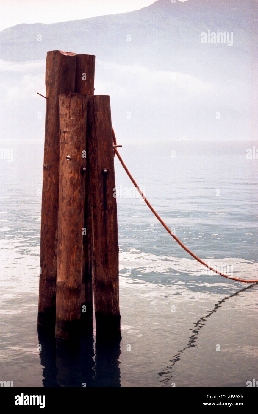 Holzpfaehle zum Befestigen von Booten im Gardasee in Italien Stock Photo