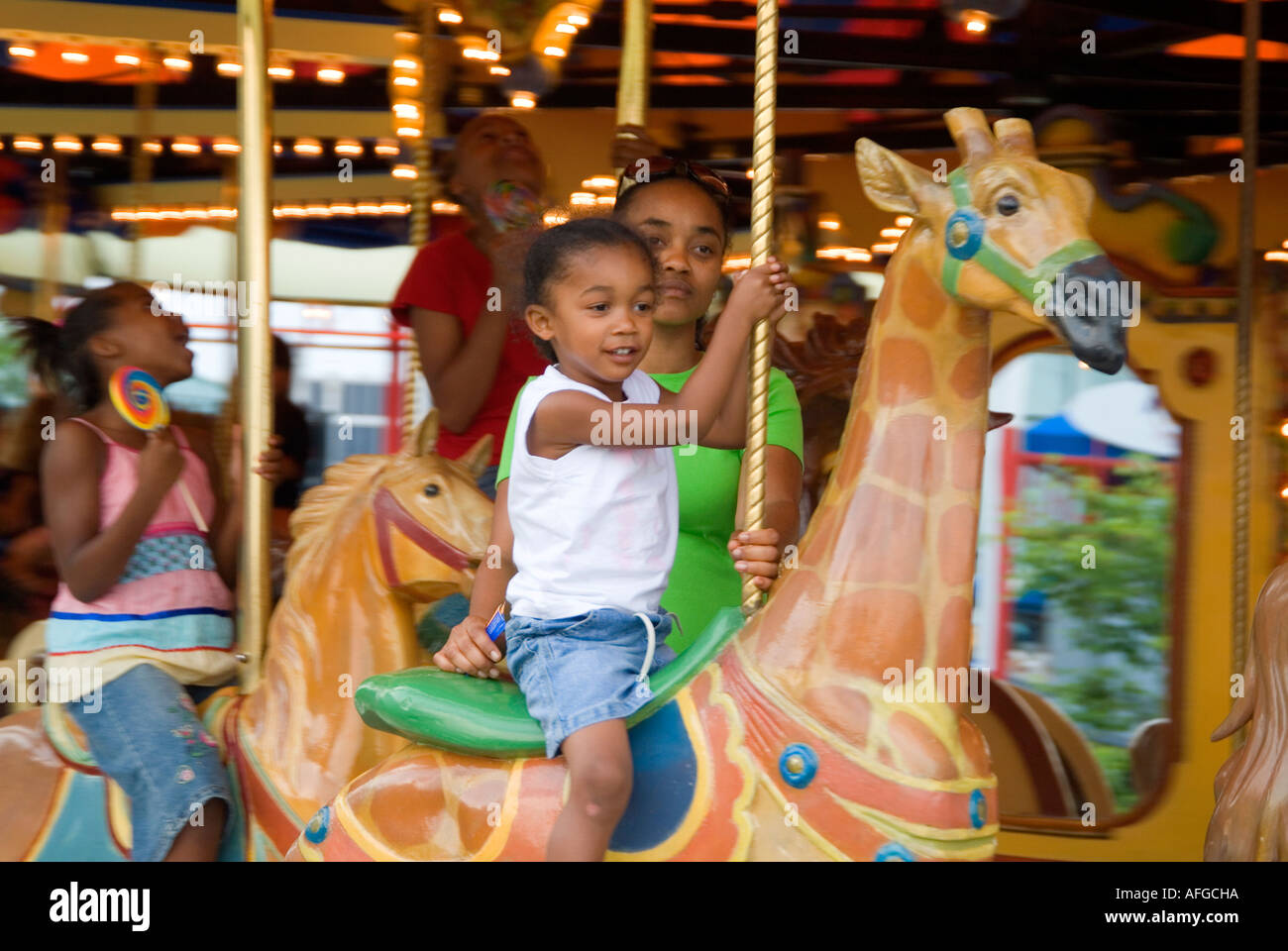 Child rides on carousel hi-res stock photography and images - Alamy