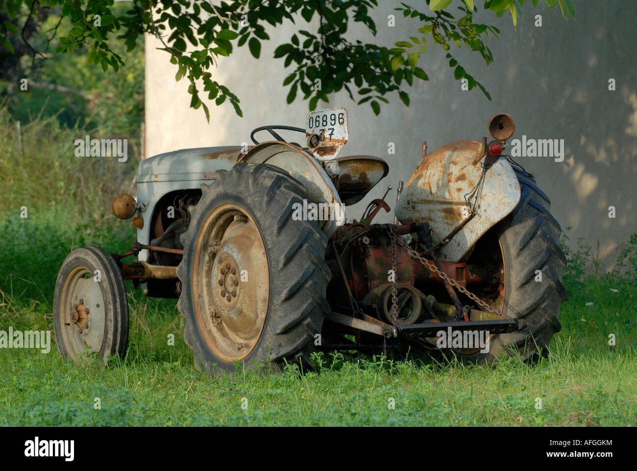Old tractor under Walnut tree, Indre, France Stock Photo - Alamy