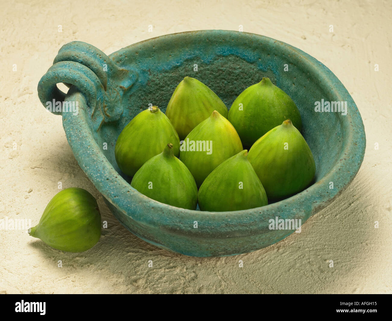 GREEN FIGS IN BLUE BOWL Stock Photo