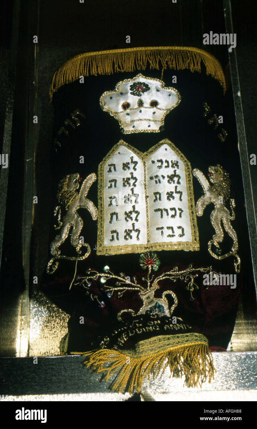 A richly embroidered mantle covers the sacred Hebrew scrolls which are ...