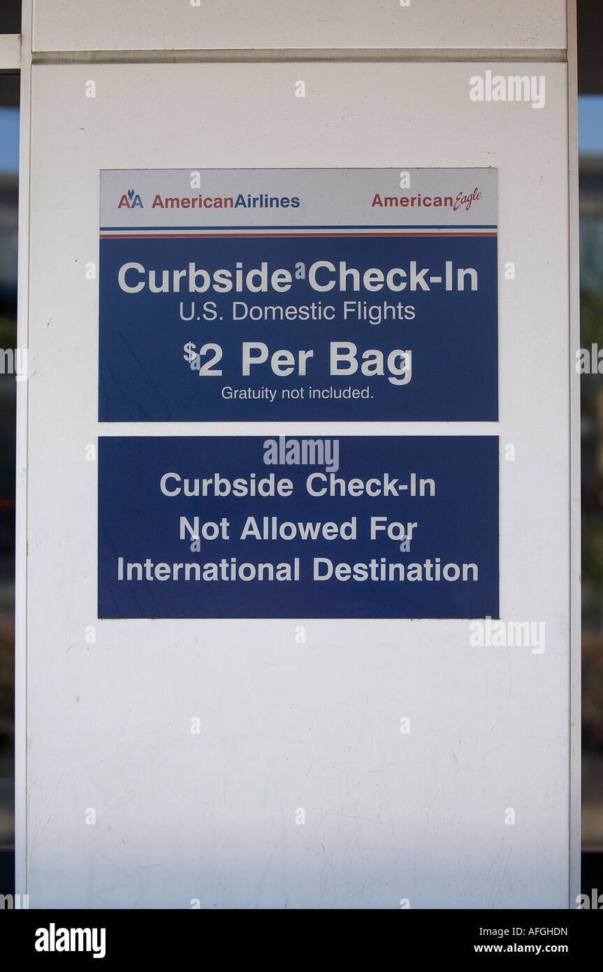 American Airlines sign tells passengers that there is a charge of 2 00 per bag for curbside check in Stock Photo