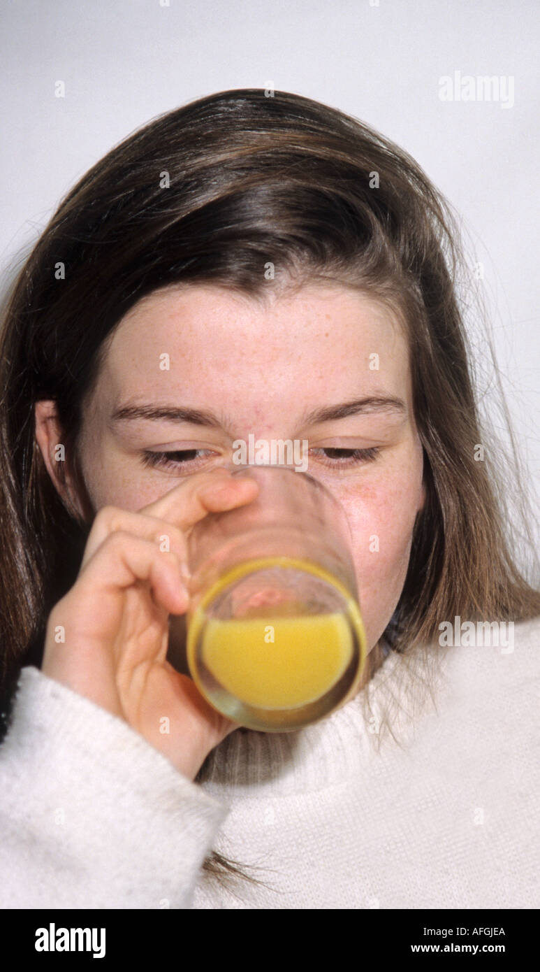 young woman drinking orange juice Stock Photo Alamy