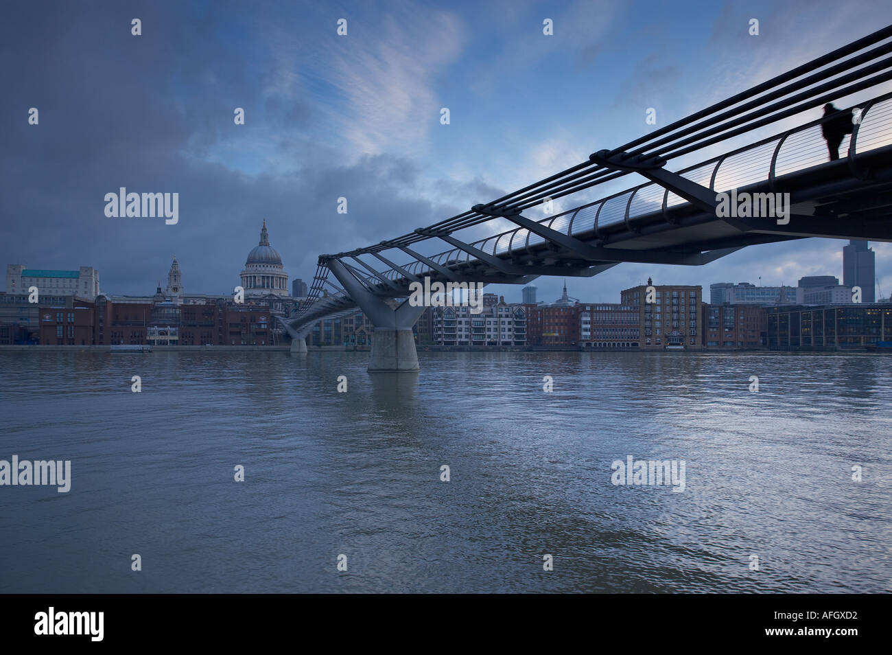 Man on the Millennium Bridge over the River Thames to St Pauls Cathedral London England UK Stock Photo