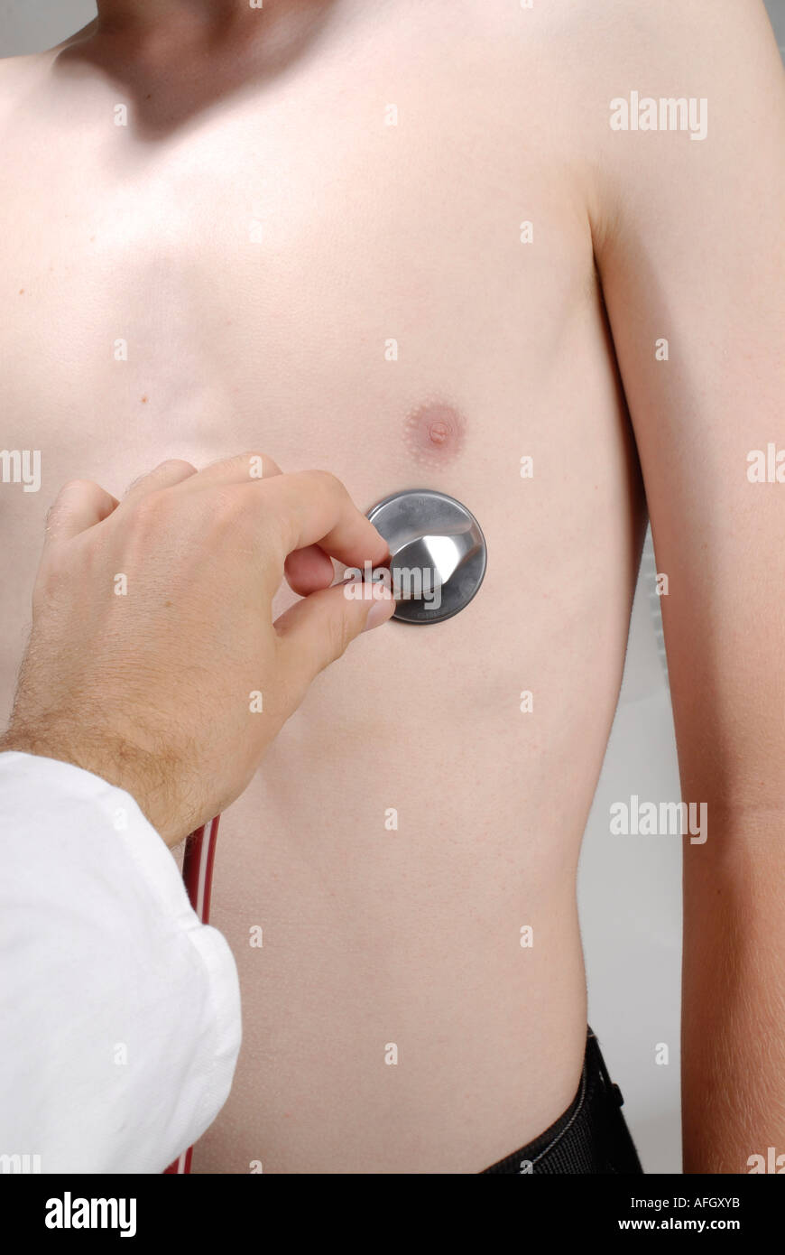 MR doctor examines patient with a stethoskop Stock Photo