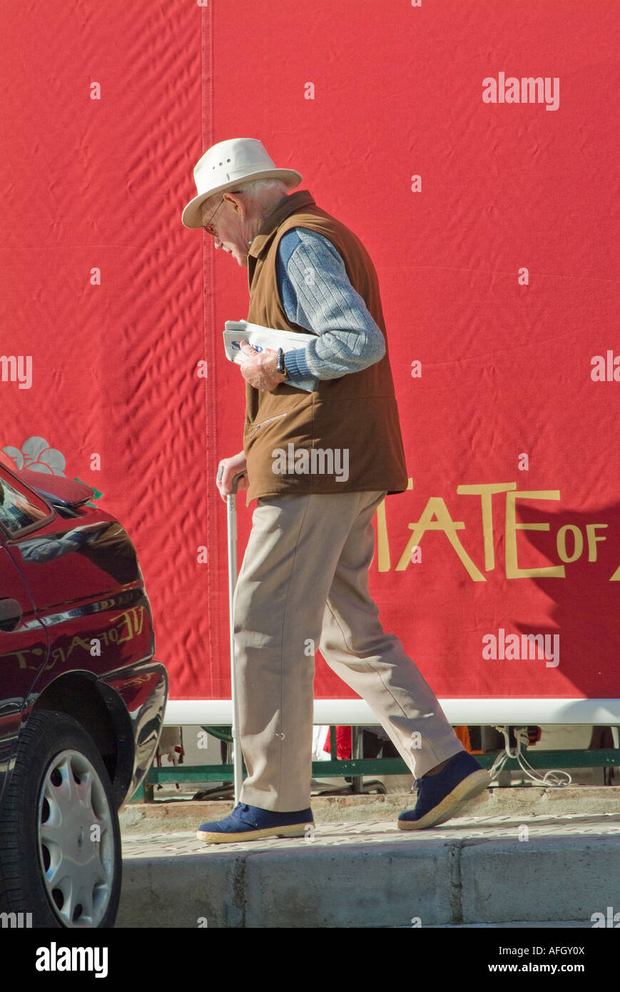 Elderly senior man walking with cane in Nerja Spain Stock Photo