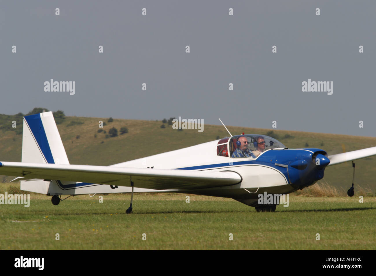 Slingsby T61 Venture motor glider taking off from a grass airfield Stock Photo
