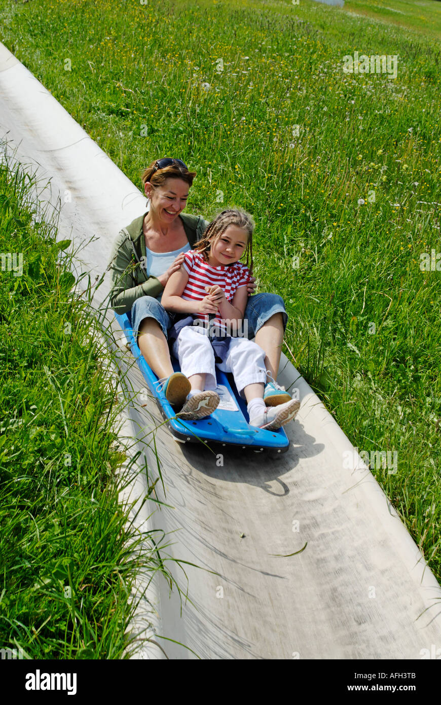 Mother and child on a toboggan hires stock photography and images Alamy