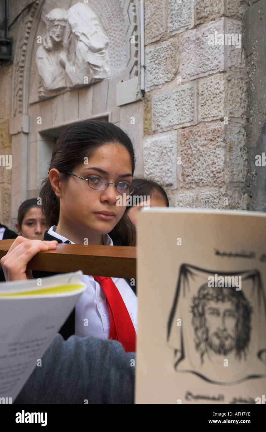 Israel Jerusalem Old City Via Dolorosa Good Friday catholic processions portrait of Palestinian female pilgrim carrying the cros Stock Photo