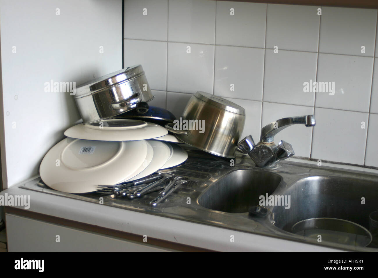 Messy kitchen sink with clean dishes Stock Photo - Alamy