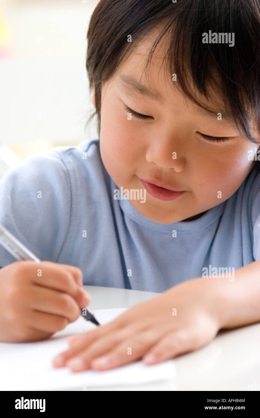 Young Boy Writing Stock Photo - Alamy