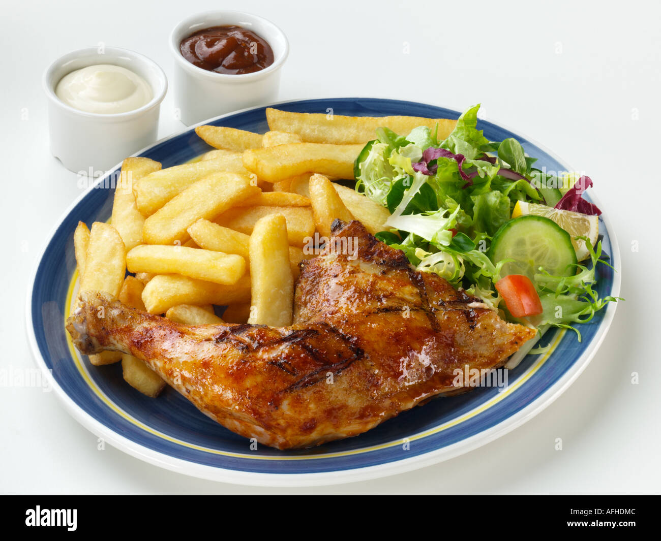 Chicken leg French fries and salad Stock Photo - Alamy