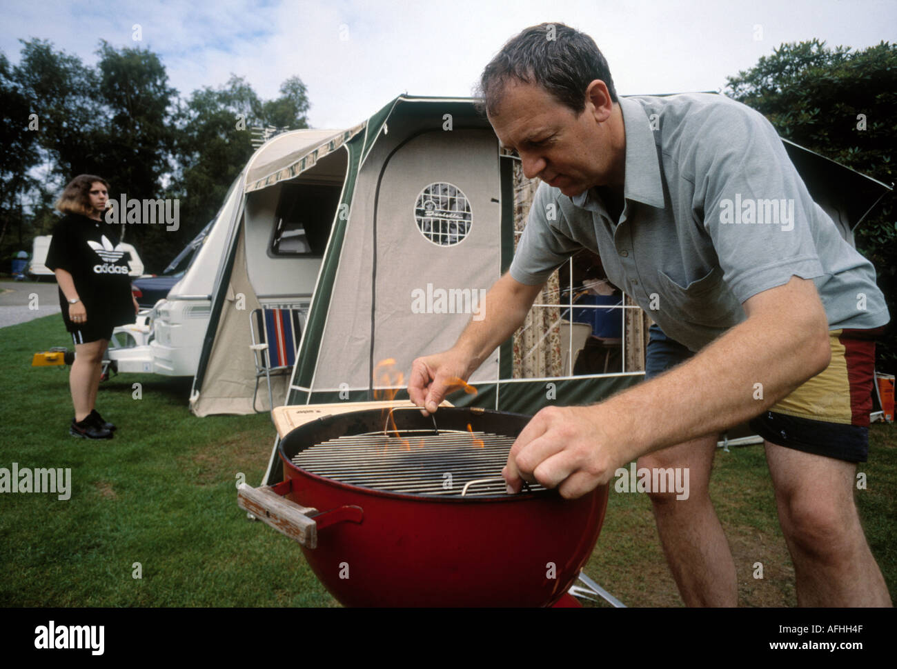 Caravaning holiday makers have a barbecue in Hastings South England UK Stock Photo