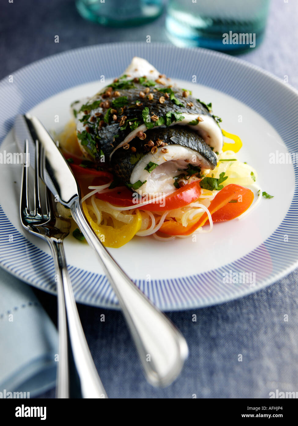 Fine dining rolled baked sea bass red yellow peppers spaghetti hires