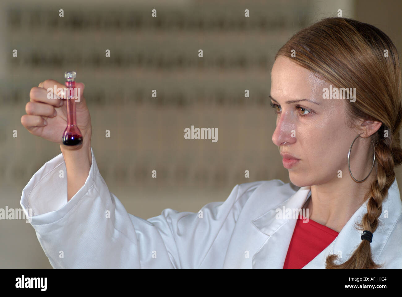 Scientist Studying the Content of a Test Tube in a Laboratory Stock Photo