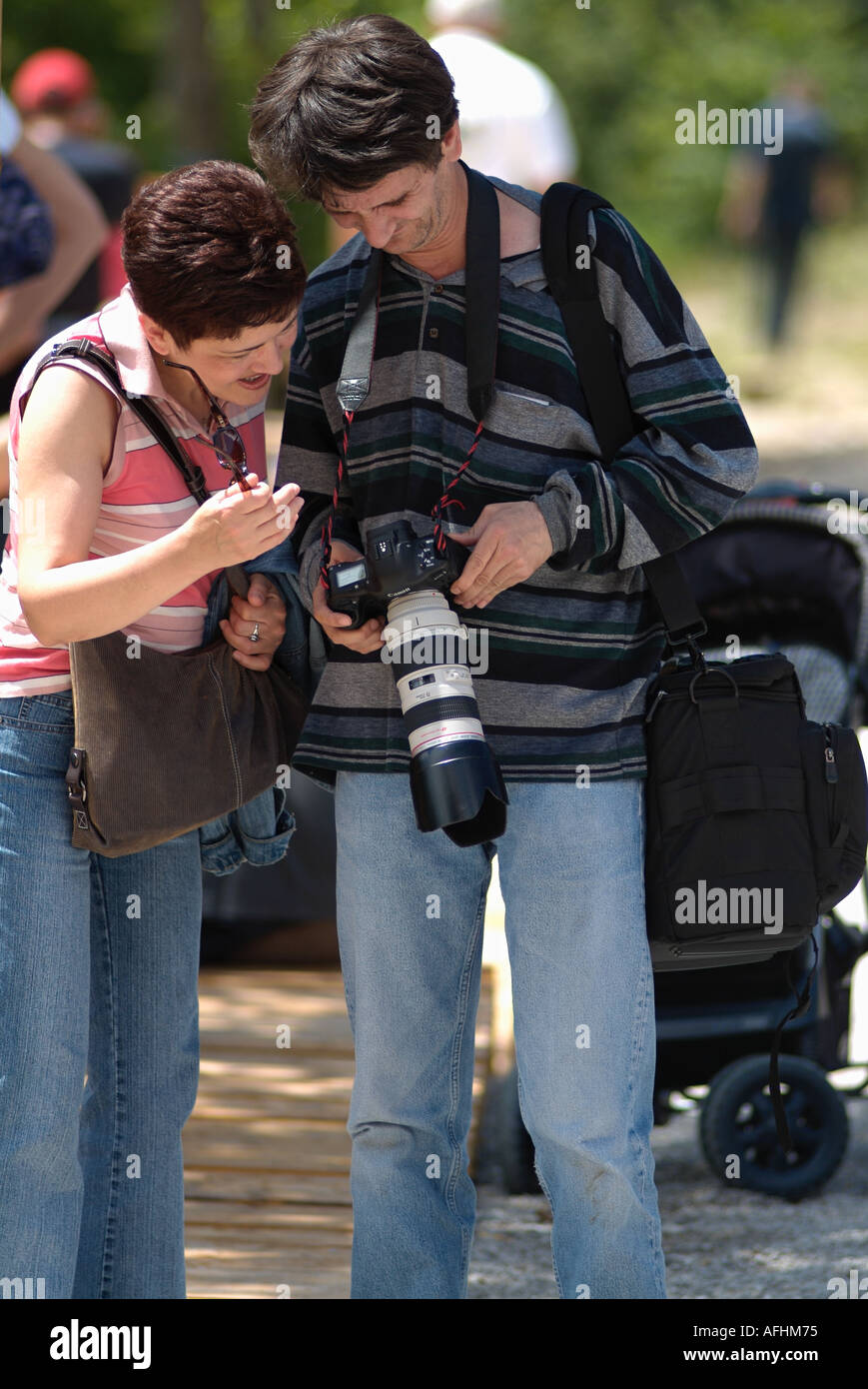 Photographer Showing a Woman a Picture on the Display of His Digital SLR Camera Stock Photo