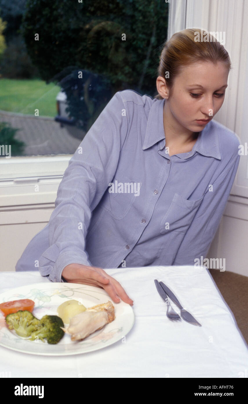 teenage girl pushing away food Stock Photo