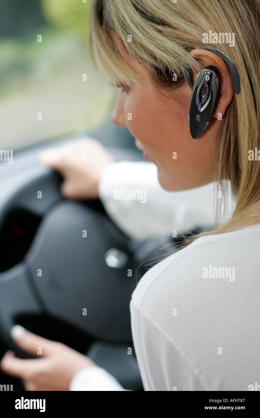 woman with hands free mobile phone in the car Stock Photo