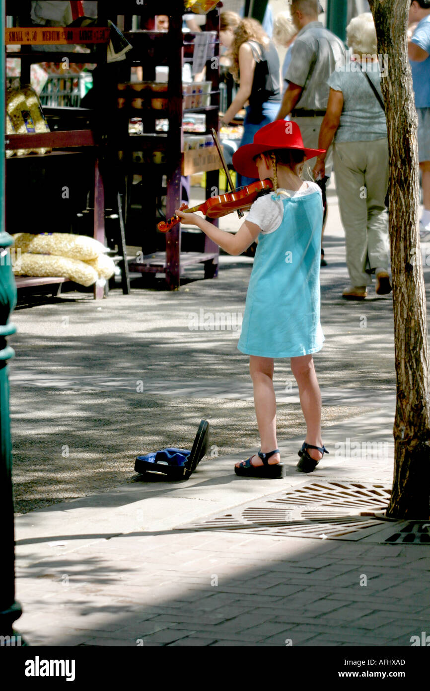 Little girl fiddler “busking” Stock Photo
