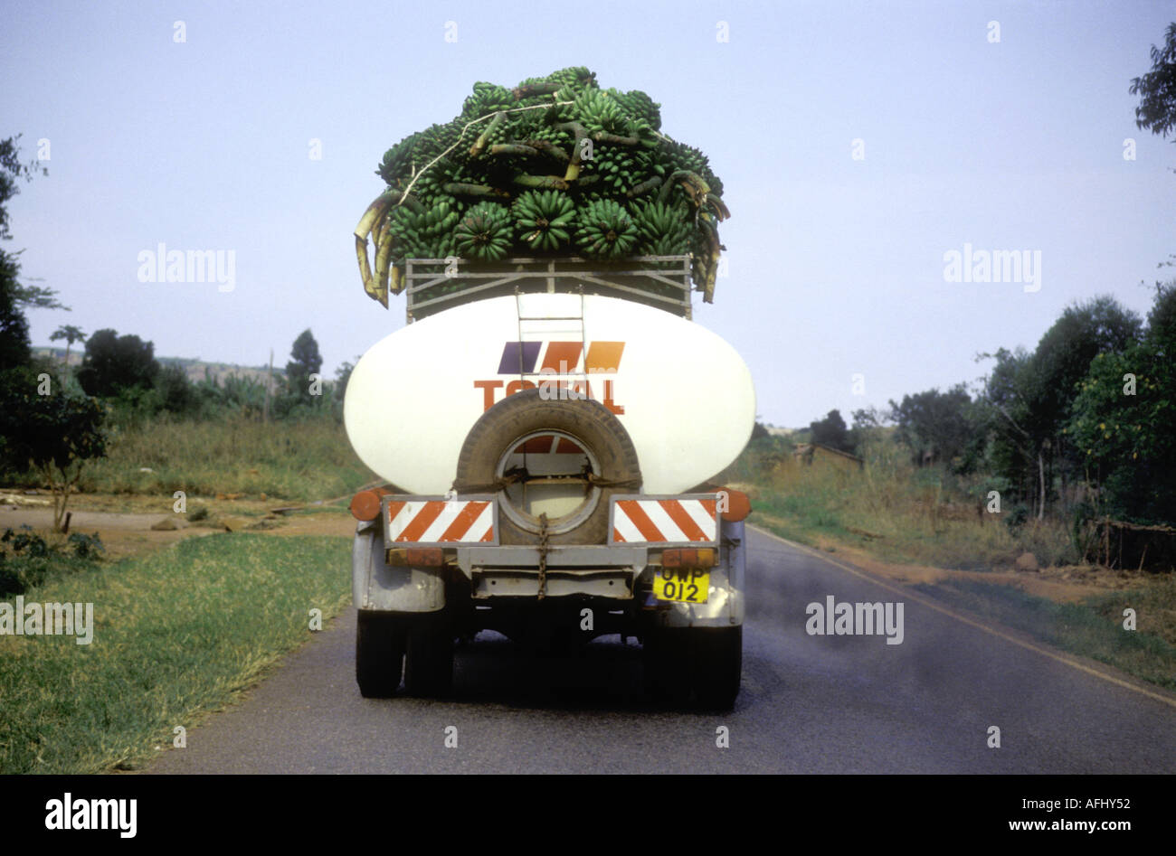 Total petrol or gasoline tanker with load of bananas on top Uganda Stock Photo