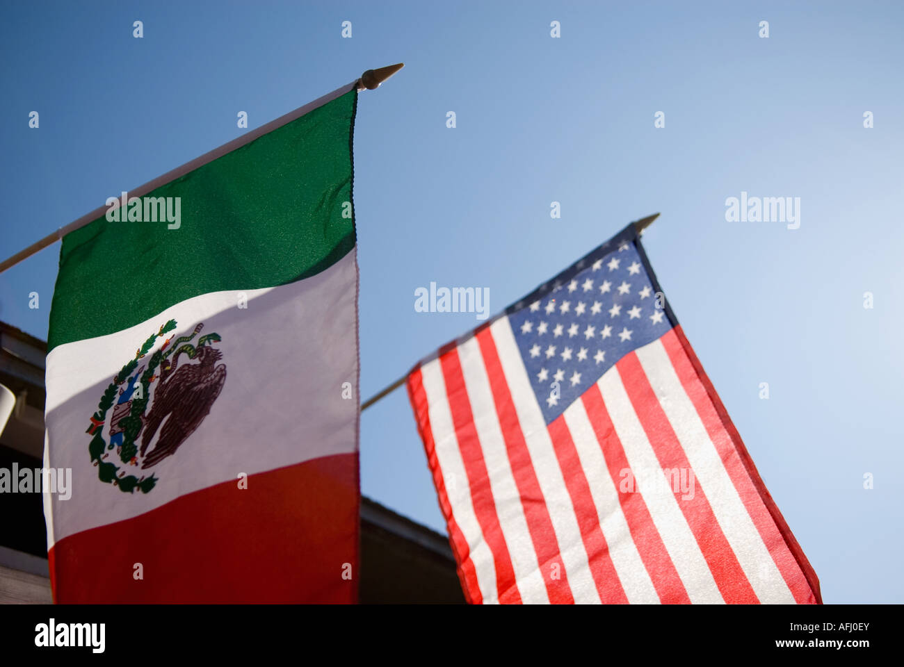 Low angle view of an American flag and a Mexican flag Stock Photo