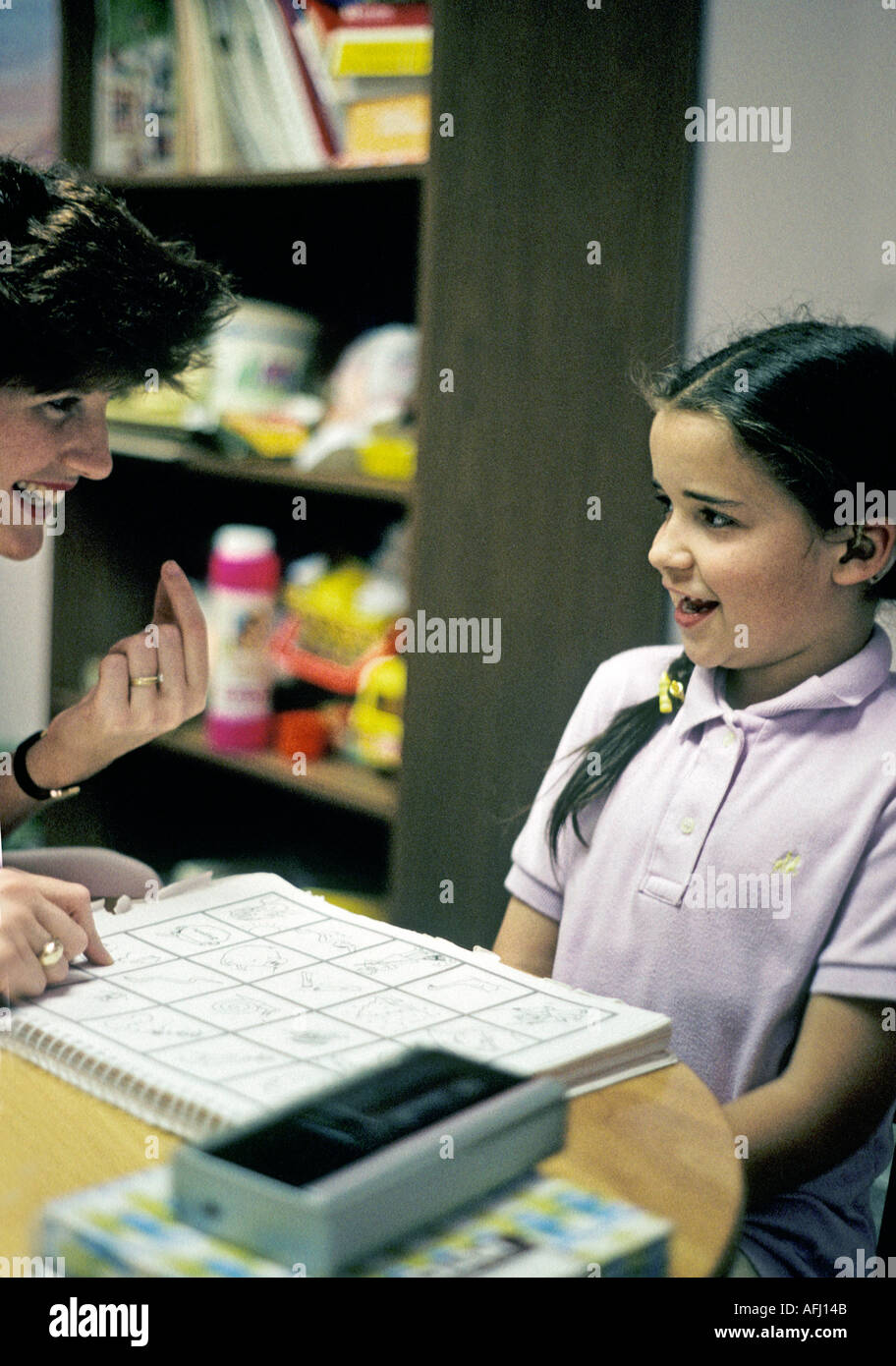 Hearing impaired child with hearing aids receiving speech therapy at
