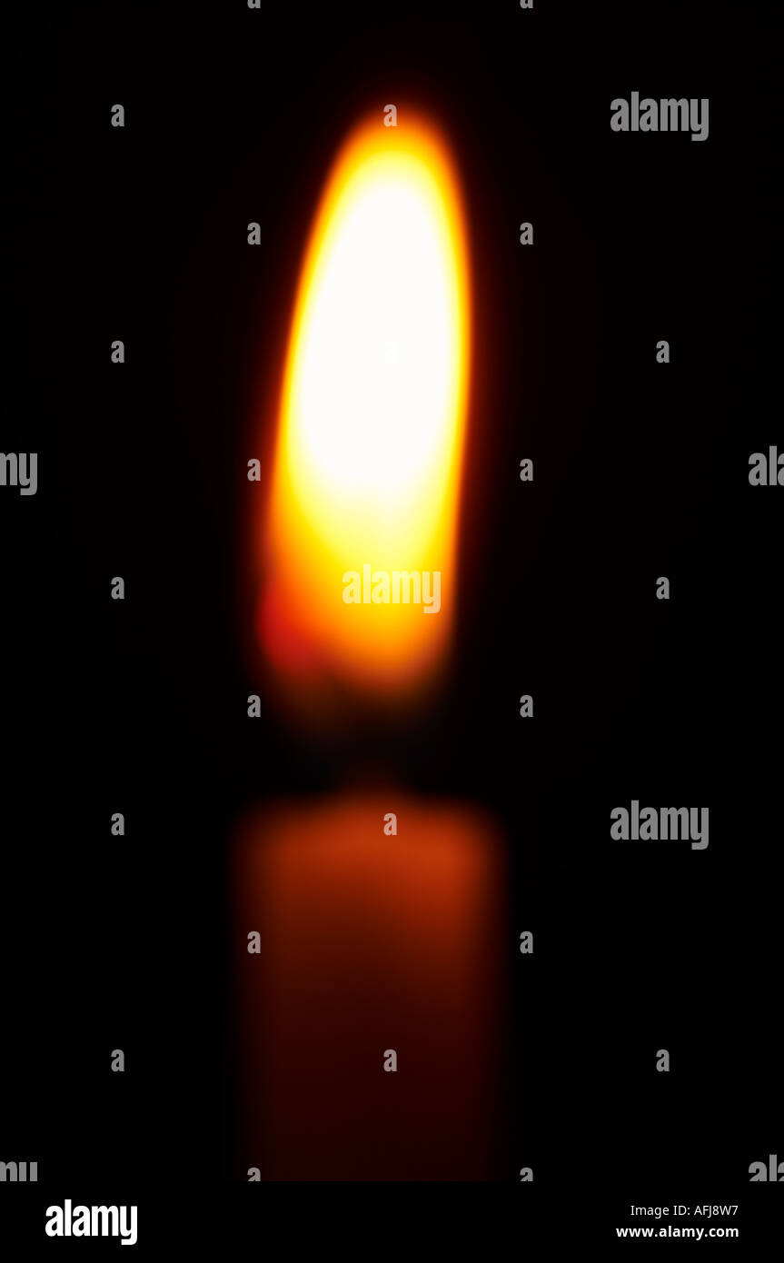 Single burning candle out of focus abstract Stock Photo