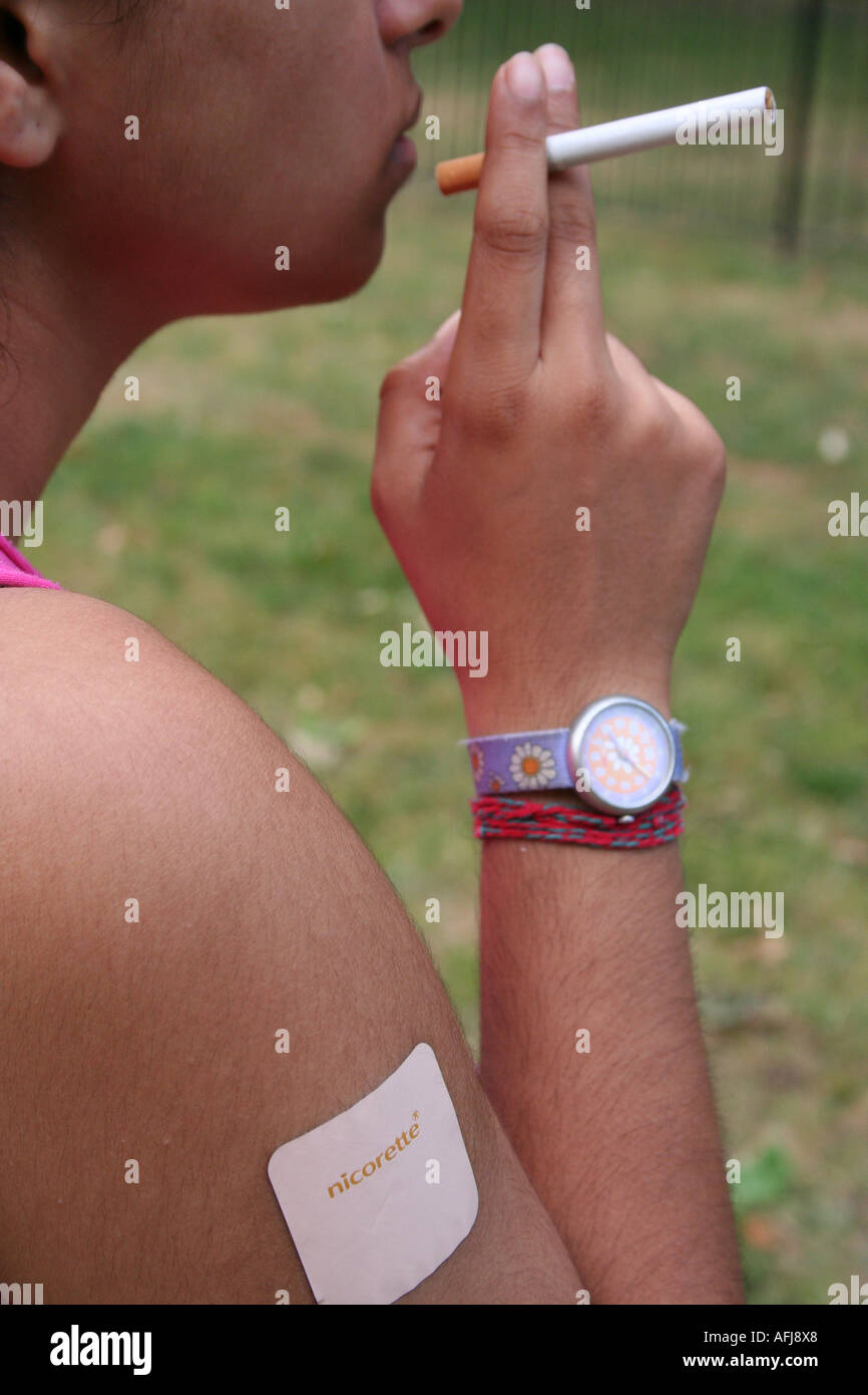 smoking a cigarette with a nicotine patch on Nicotine patch hi-res stock photography and images - Page 2