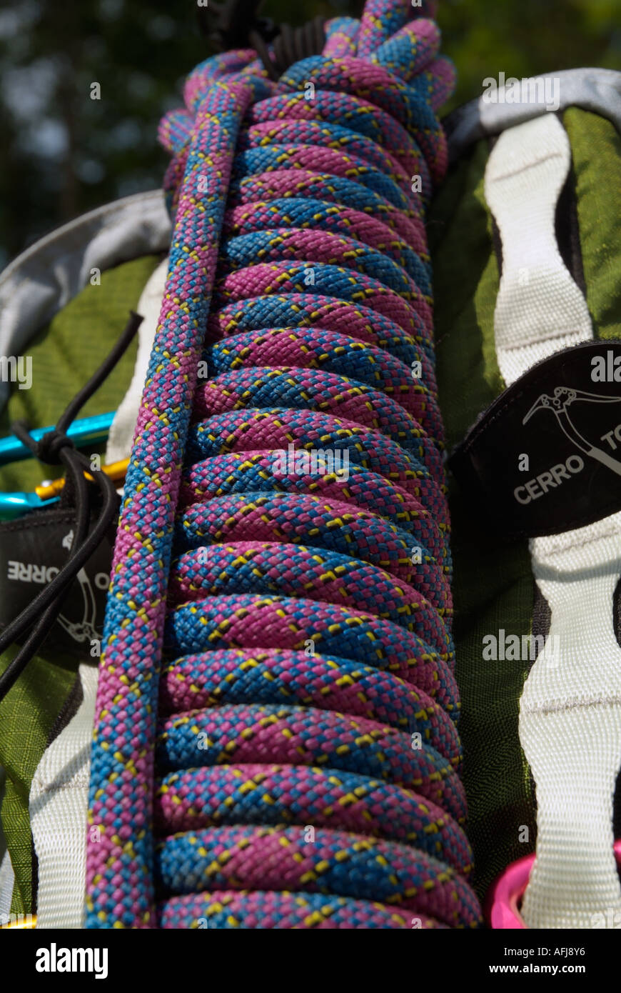 A purple climbing rope attached to a backpack Stock Photo - Alamy