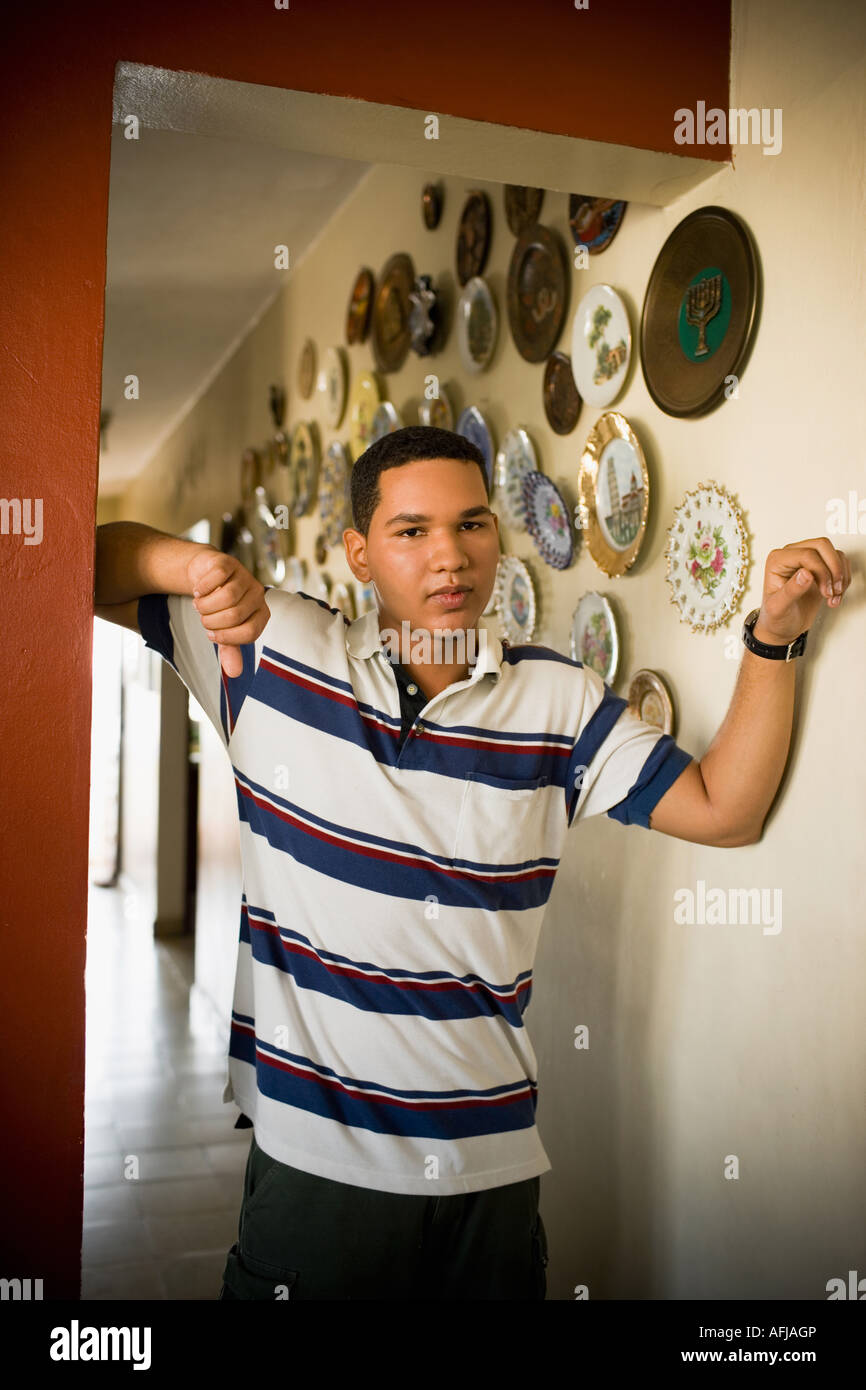 Young man leaning against a wall Stock Photo - Alamy