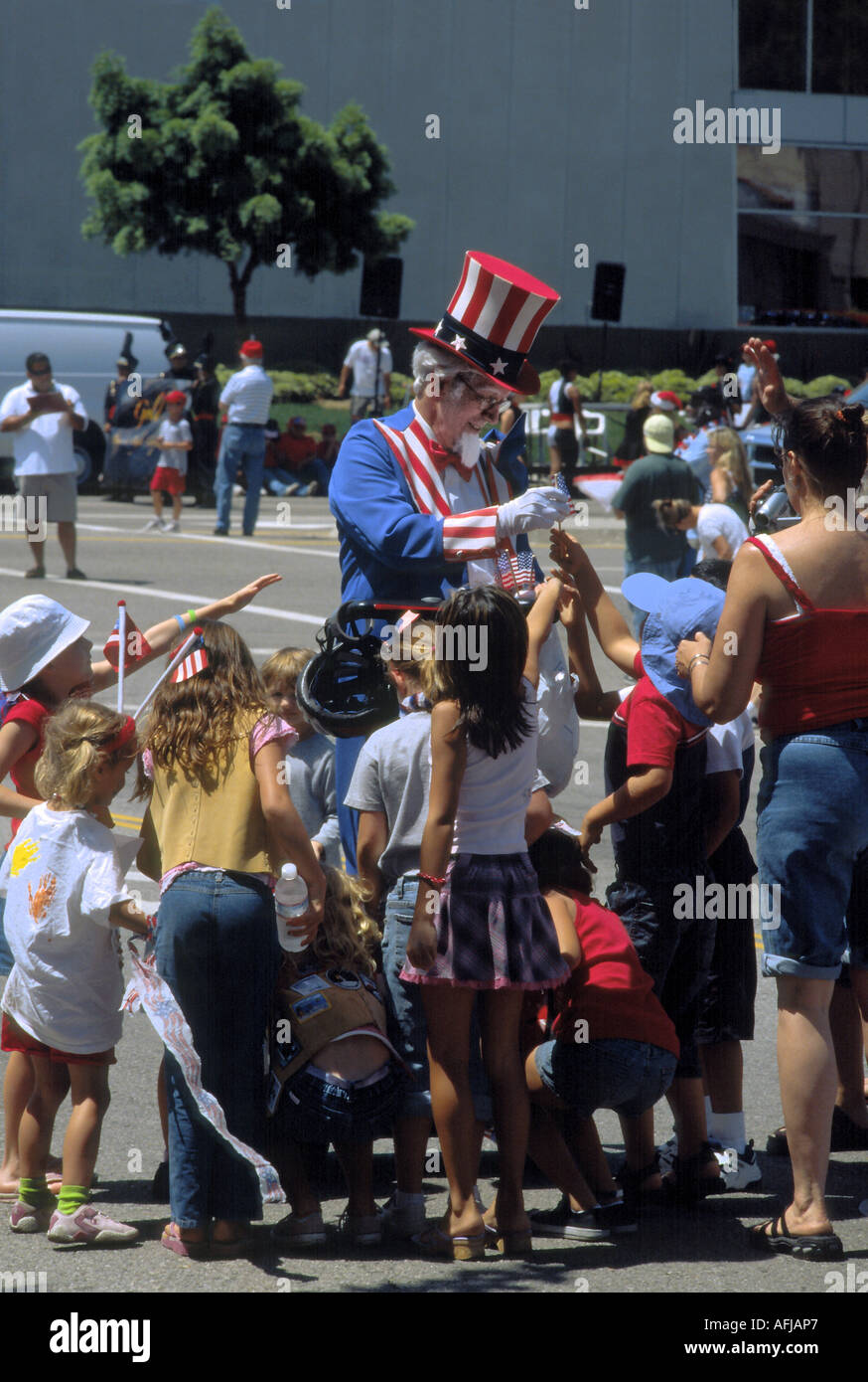 An Uncle Sam figure gathers a group of kids during July Fourth celebrations in Westchester, Los Angeles, California Stock Photo