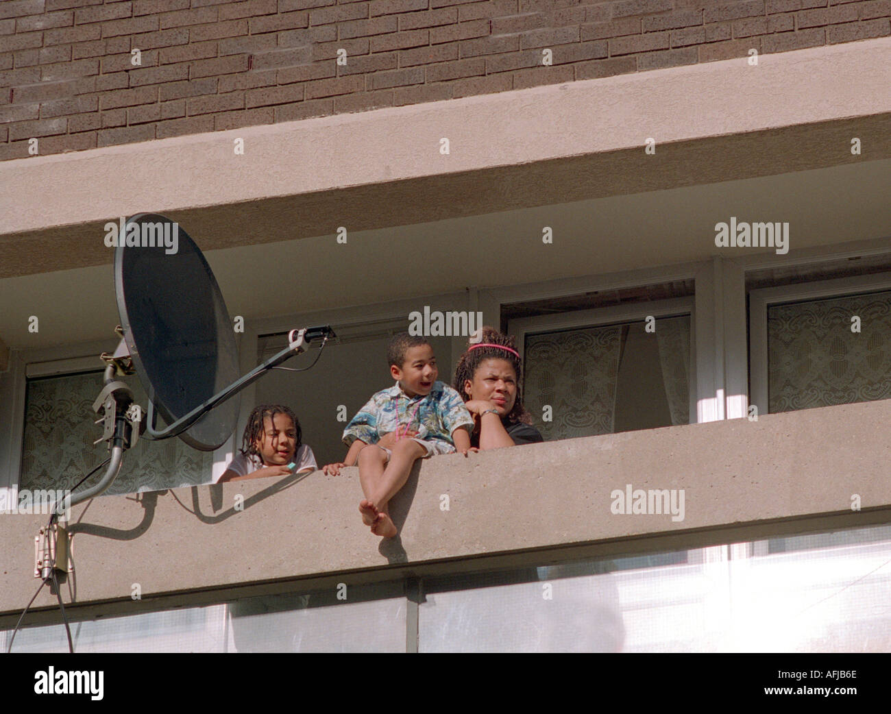 Residents in West London housing estate on their balconies the world going by. Stock Photo